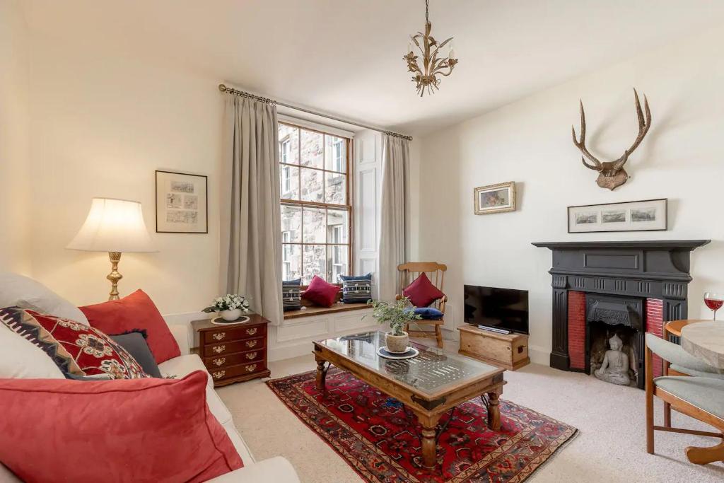 sala de estar con sofá y chimenea en Stunning Panoramic Views: Heart of the Royal Mile, en Edimburgo