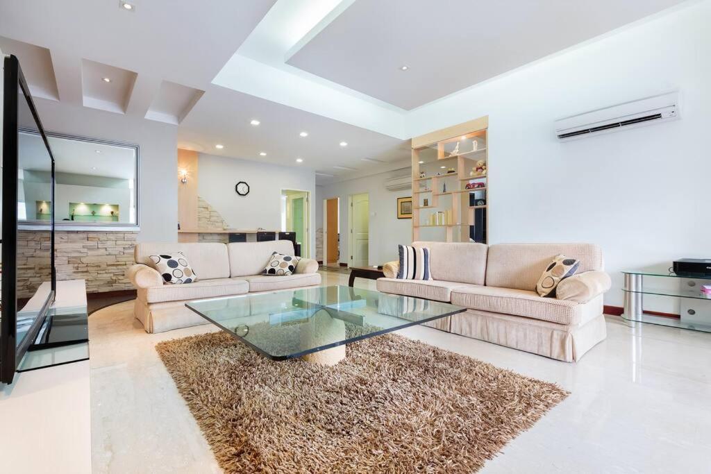 a living room with two couches and a glass table at The Center of Singapore; China Town in Singapore