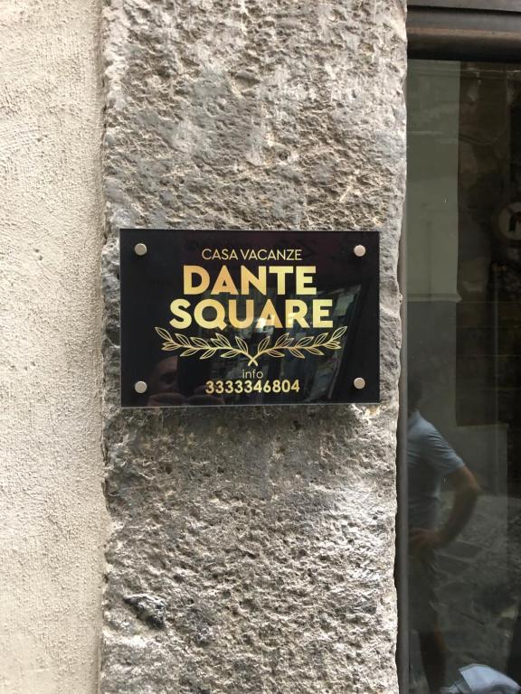 a sign for a dance square on the side of a building at Dante Square in Naples