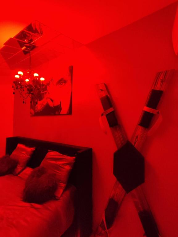 - une chambre rouge avec un lit au plafond rouge dans l'établissement Gîte Ange ou Démon, jacuzzi, sauna, marchés de Noël, à Benfeld