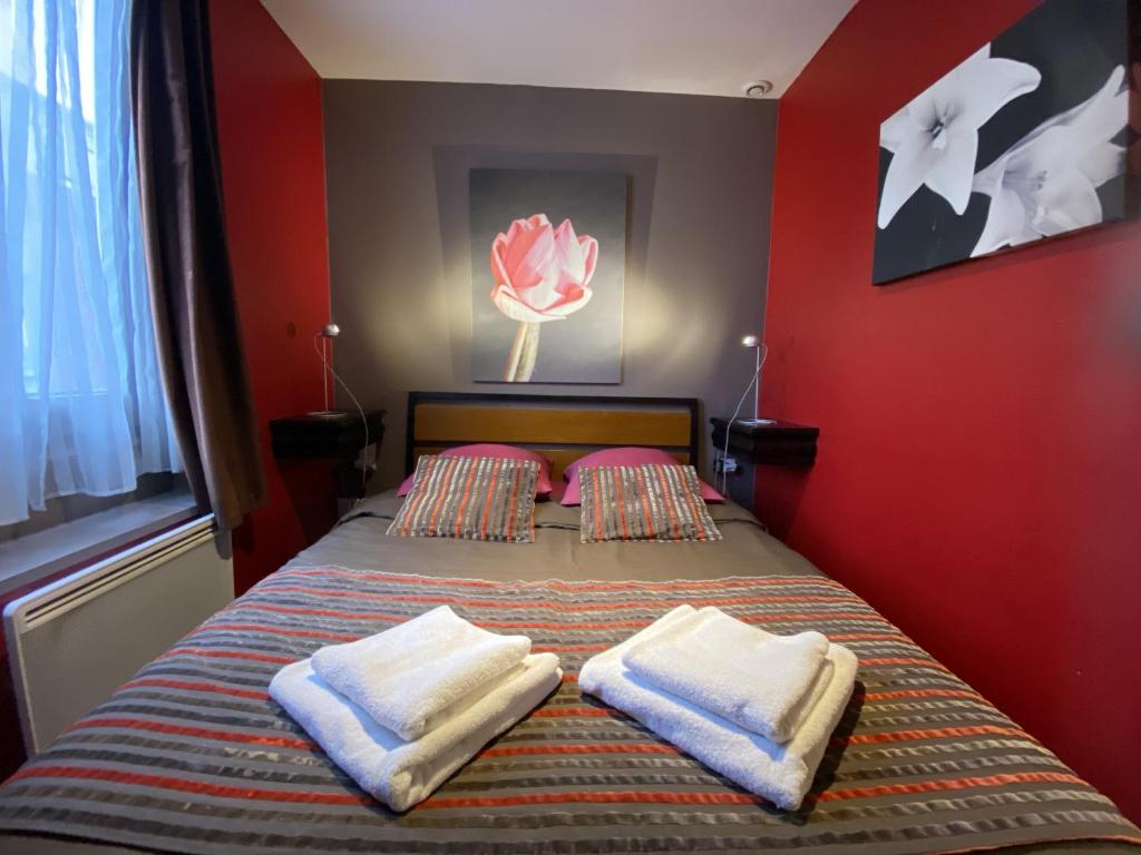 a bedroom with a bed with two pillows on it at Loger à La Madeleine in La Madeleine