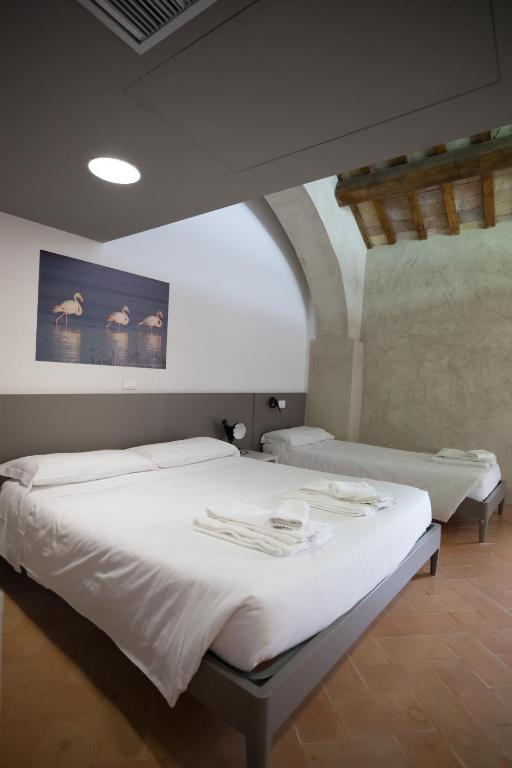 A bed or beds in a room at Ostello del Castello di Santa Severa