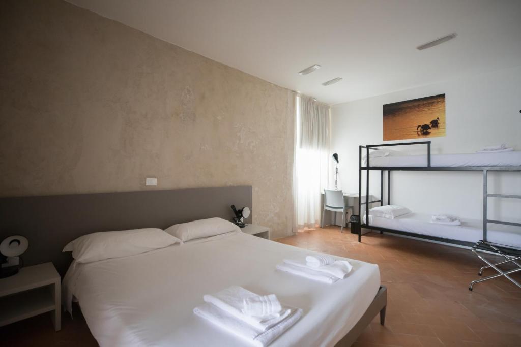 A bed or beds in a room at Ostello del Castello di Santa Severa