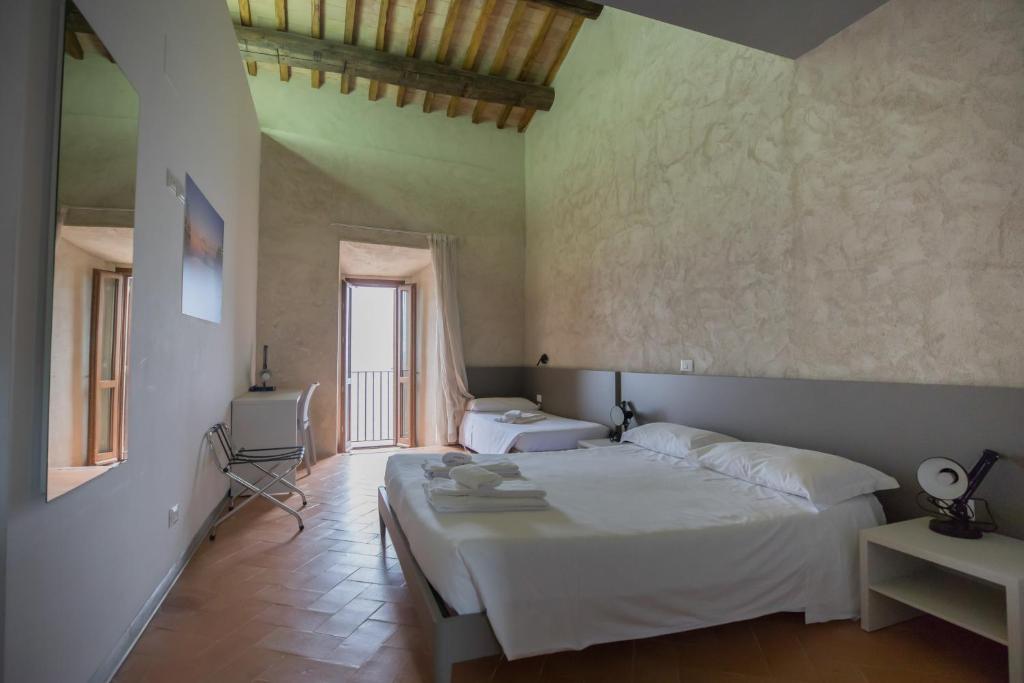 A bed or beds in a room at Ostello del Castello di Santa Severa