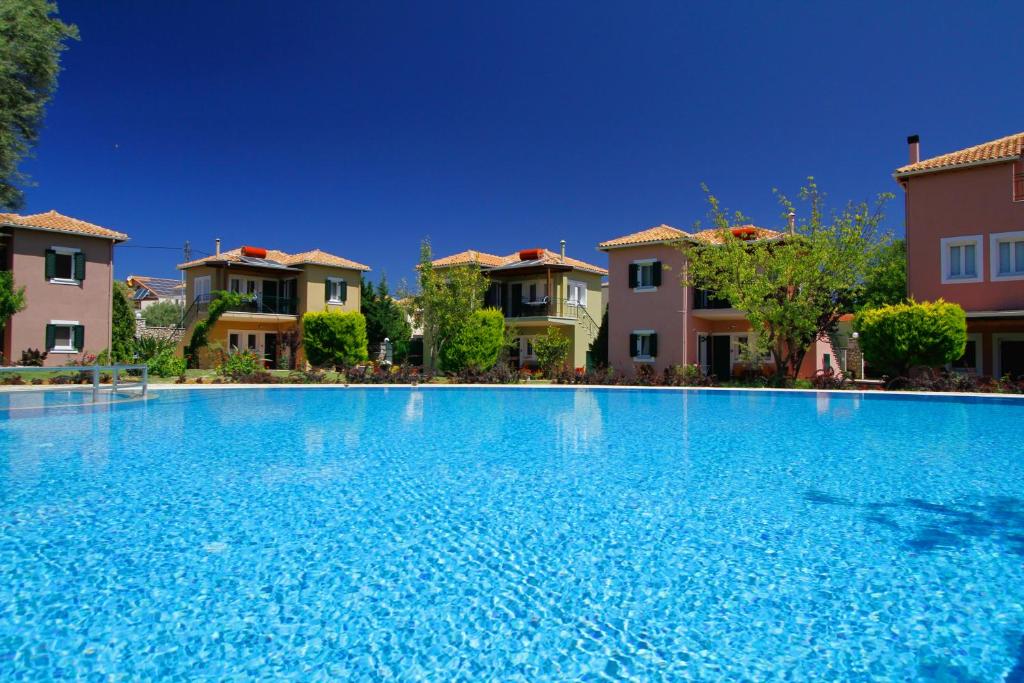 a large swimming pool in front of some houses at Saint Thomas Village in Lefkada