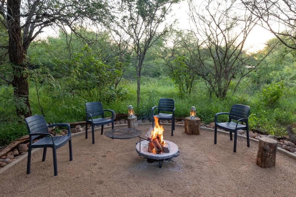 a group of chairs sitting around a fire pit at Wildheart Safari - Zesty Zebra in Hoedspruit