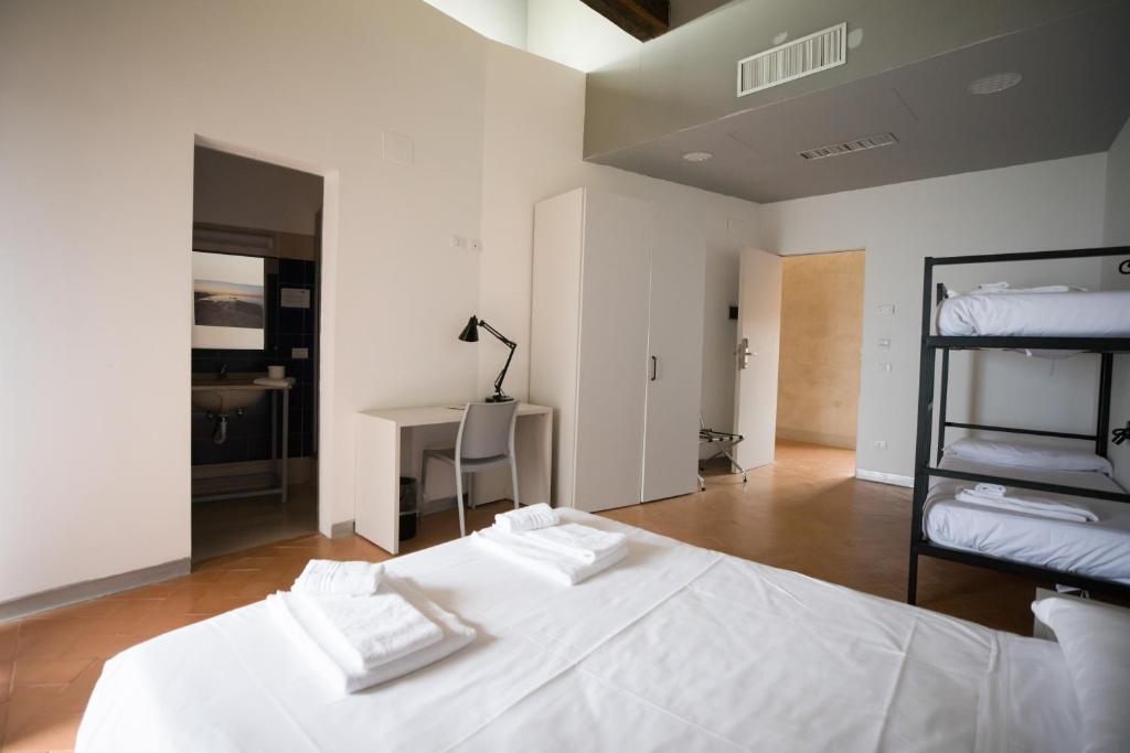 A bed or beds in a room at Ostello del Castello di Santa Severa