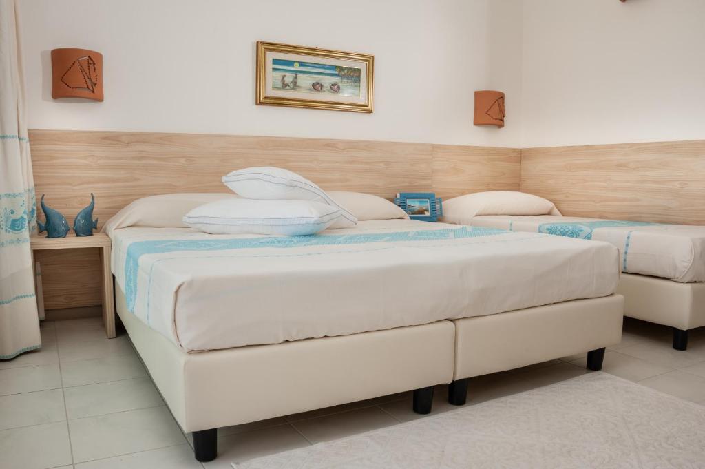 Postel nebo postele na pokoji v ubytování GH Santina Resort & SPA