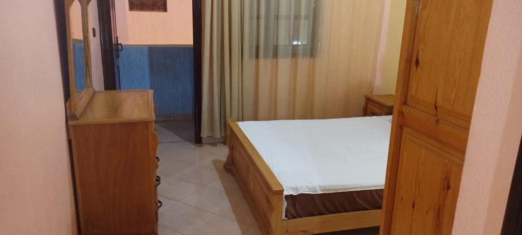 a small room with a bed and a closet at Leila in Agadir