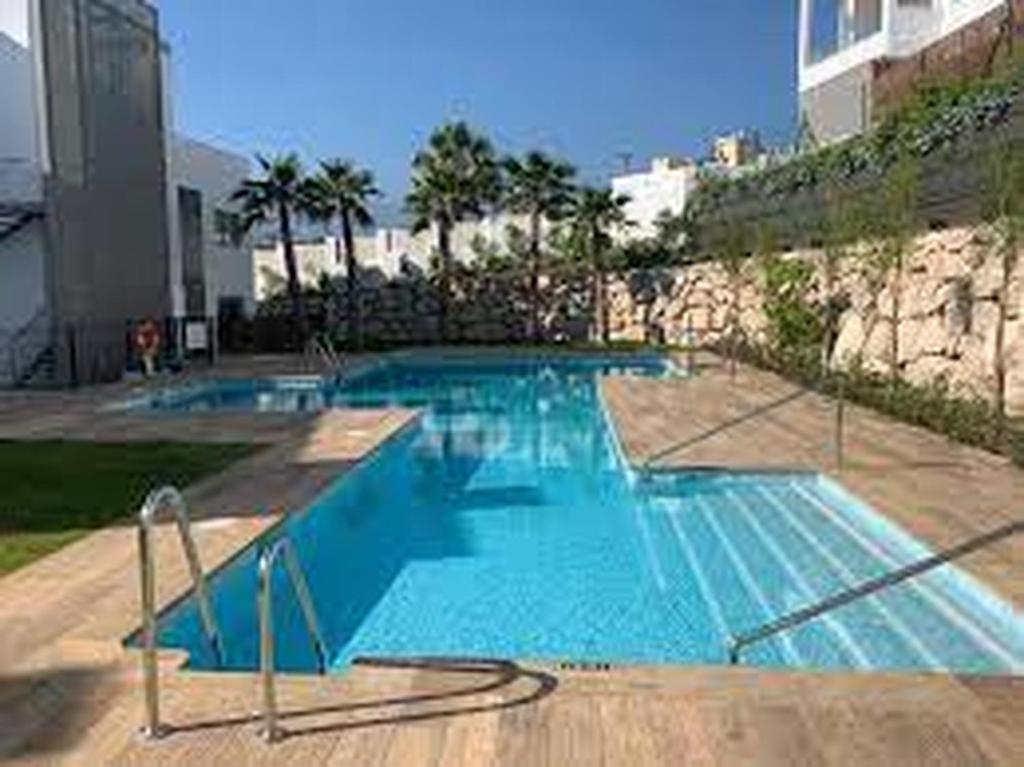 a large blue swimming pool in a building at Baviera Hills 1a in Málaga