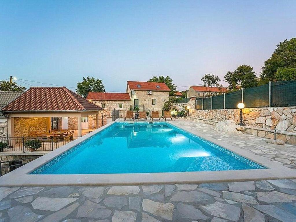einen Pool in einem Hof mit einem Haus in der Unterkunft Holiday house Buljanovi Dvori with private pool in Runović