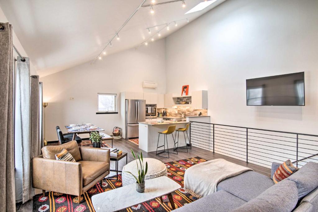 a living room with two couches and a kitchen at Contemporary-Boho Loft in Downtown Livingston! in Livingston