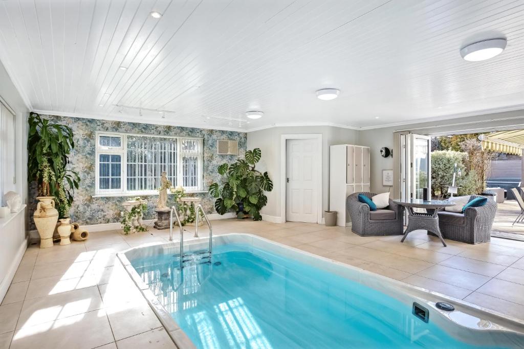 a home with a swimming pool in a living room at The Coast House B&B and Spa in Bognor Regis