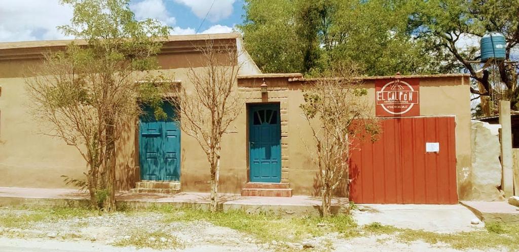 un edificio con puertas azules y rojas y una señal de stop en La Esmeralda in 