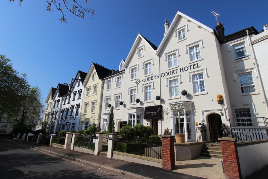 ein weißes Gebäude mit den Worten Botschafter Hotel in der Unterkunft Queens Court Hotel in Exeter