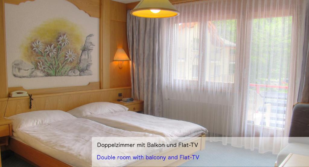 Ein Bett oder Betten in einem Zimmer der Unterkunft Hotel Restaurant Mattmarkblick