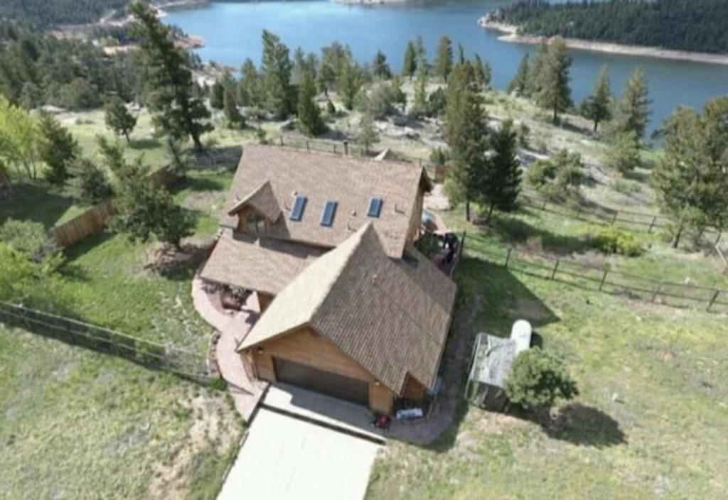 an aerial view of a house with a lake at Boulder Best City and Nature with Lake and Trails PETS OK in Boulder
