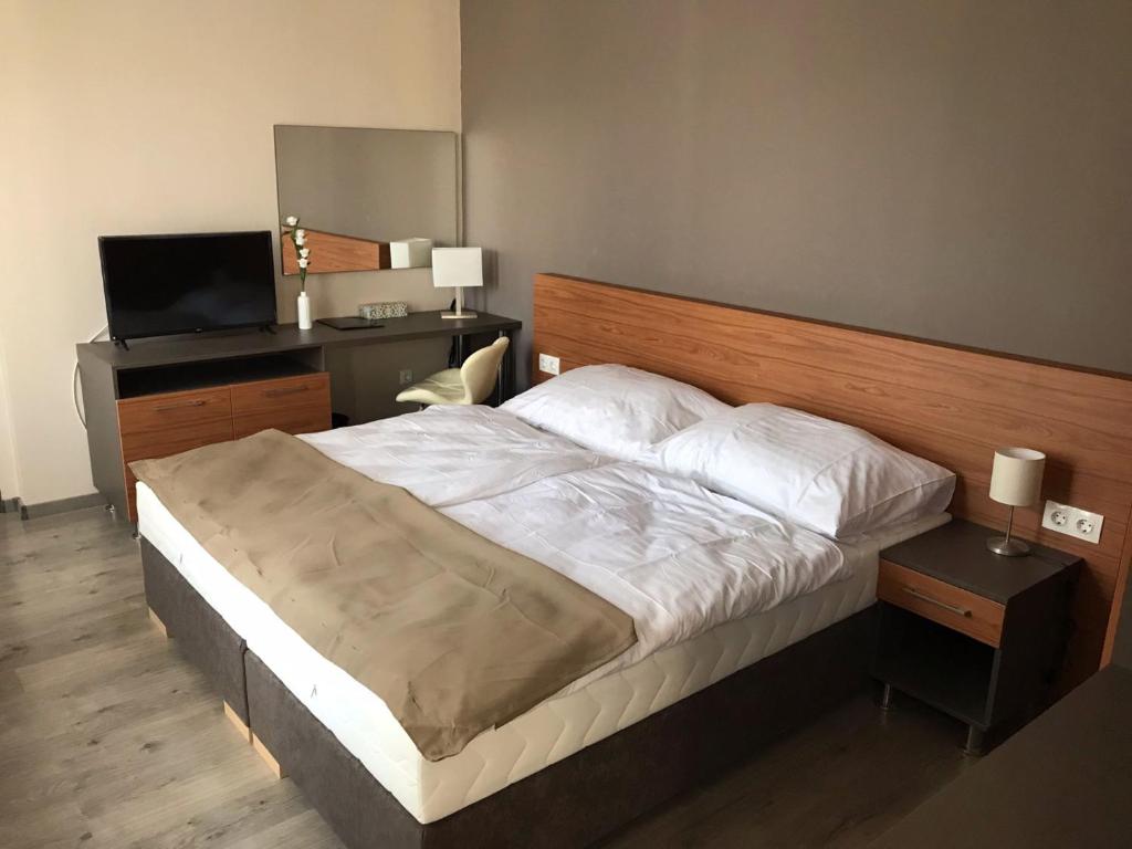 Postel nebo postele na pokoji v ubytování Centro Panzió