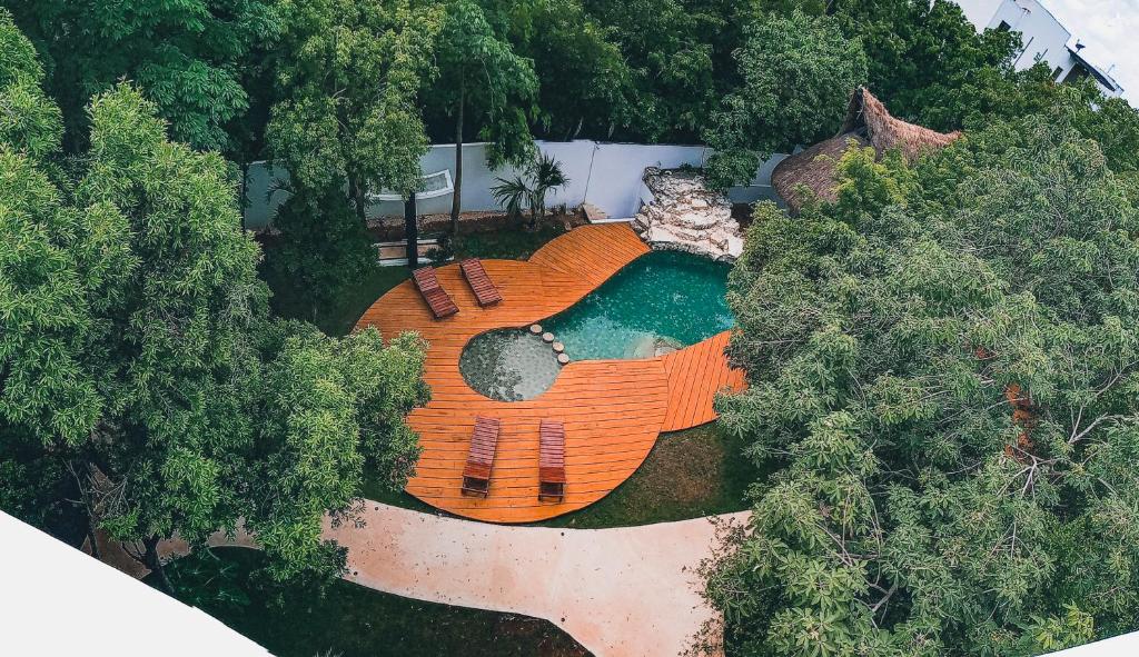 an overhead view of a backyard with a pool with benches at Coco Village in Tulum
