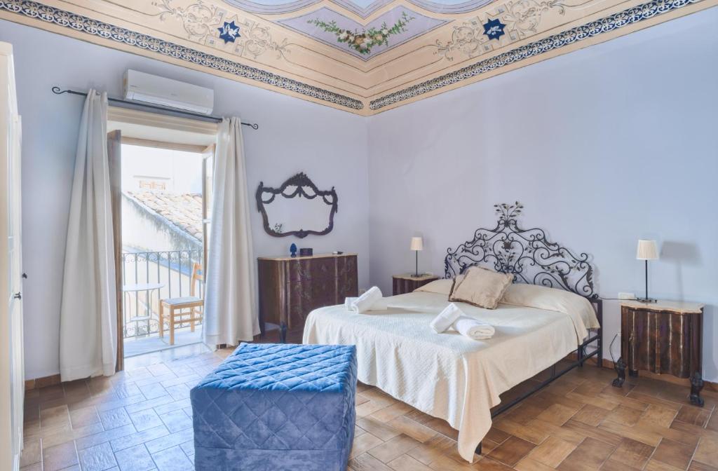 a bedroom with a bed and a coffered ceiling at Porto Salvo Apartments - by Vacation Service in Cefalù