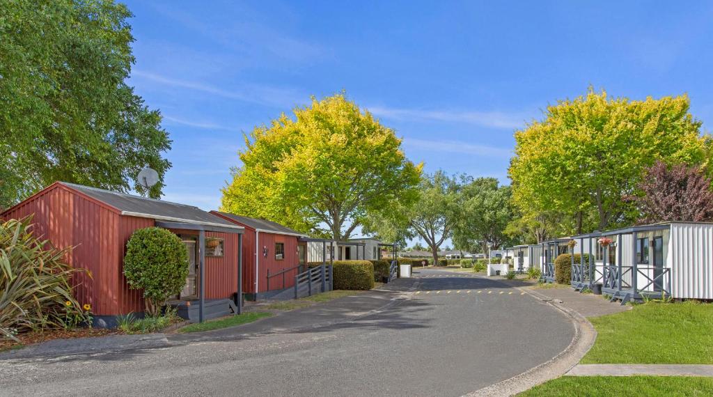 a row of mobile homes on the side of a road at Hamilton City Holiday Park in Hamilton