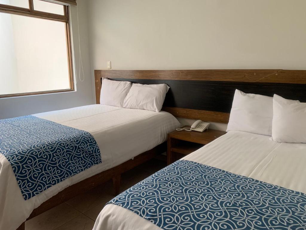 Postel nebo postele na pokoji v ubytování Rymma Hotel