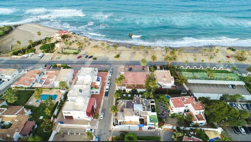 an aerial view of a beach with houses and the ocean at HOTEL BOUTIQUE CABO SUR in Mojácar