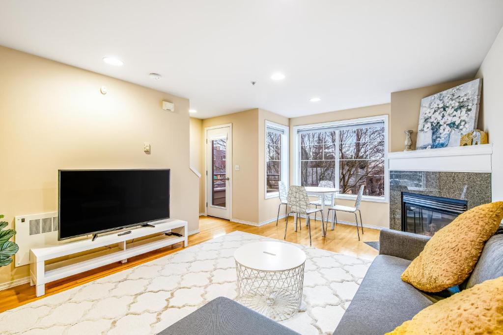 a living room with a tv and a fireplace at City Sojourn in Seattle