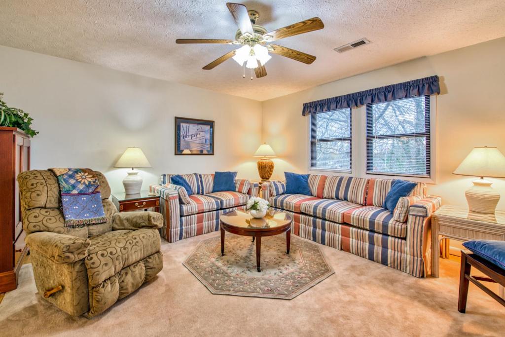 a living room with couches and a ceiling fan at Haddock Haven-3 in Lake Junaluska