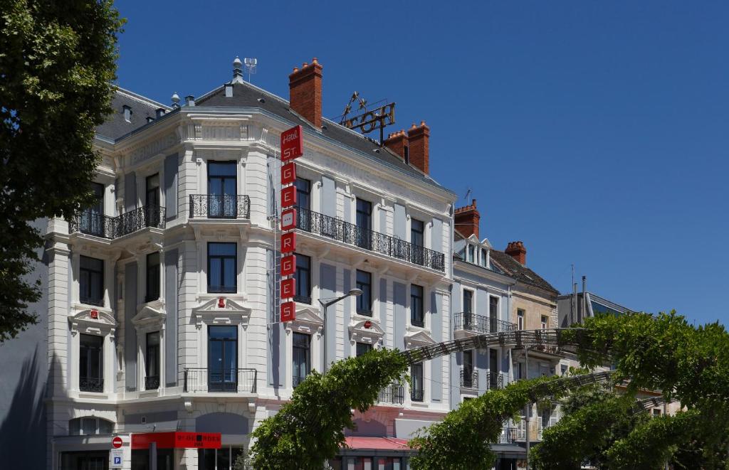 a white building with a red sign on it at Saint Georges Hotel &amp; Spa in Chalon-sur-Saône