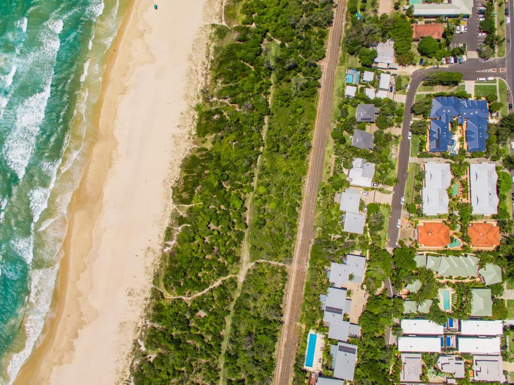 an overhead view of a beach with houses and the ocean at Byron Bay Beach Apartments in Byron Bay
