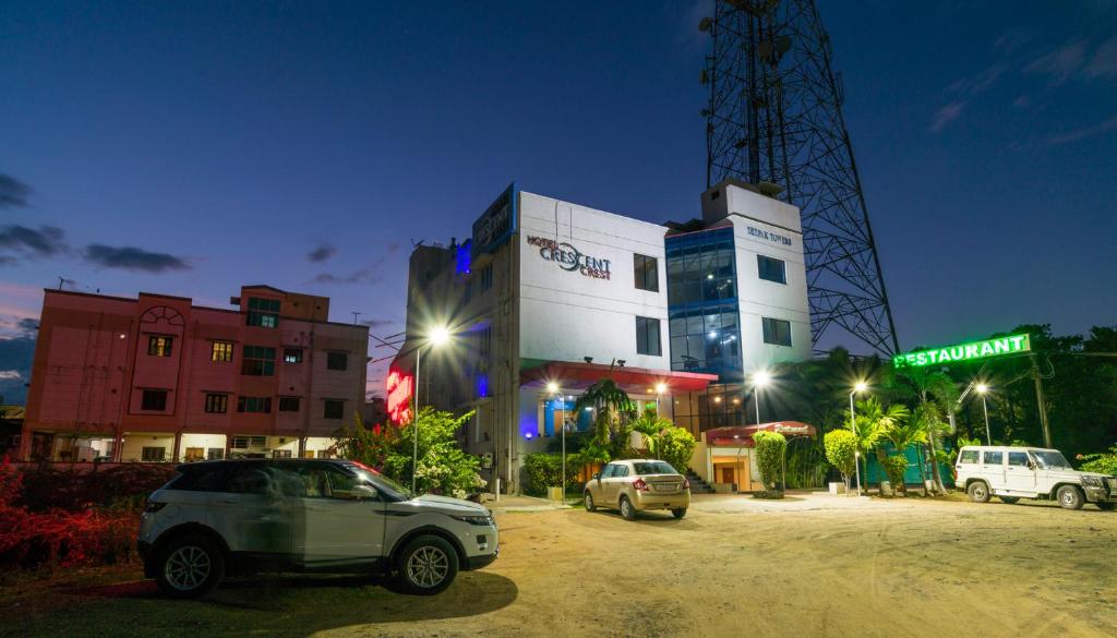 a car parked in front of a building at night at Hotel Crescent Crest Sriperumbudur in Sriperumbudur