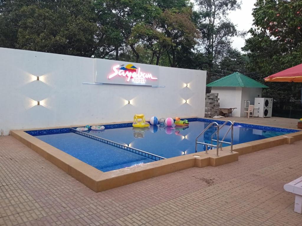a large swimming pool with a inflatable at Sayeban Hotel in Matheran