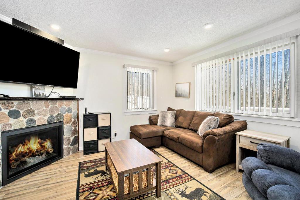 a living room with a couch and a fireplace at Hideaway Valley Condo 36 in Harbor Springs