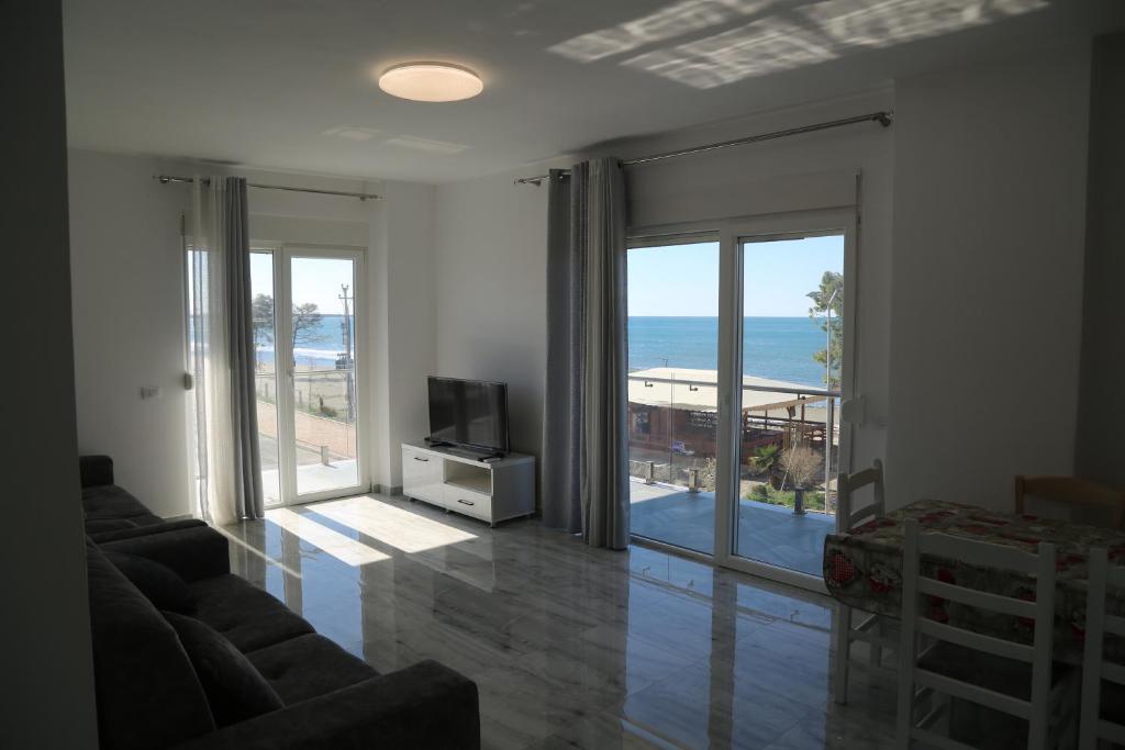 a living room with a view of the ocean at Anchor Apartments in Shëngjin