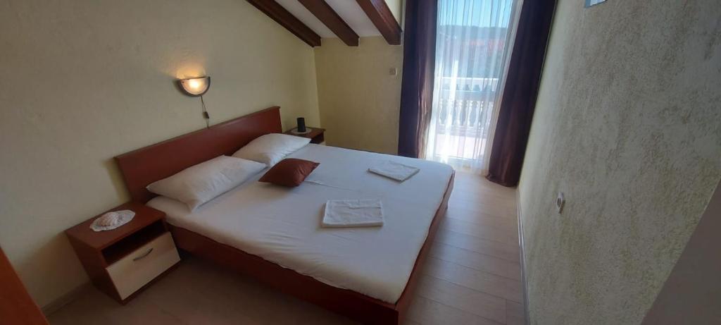 a bedroom with a bed with two towels on it at Apartments Toni in Srima