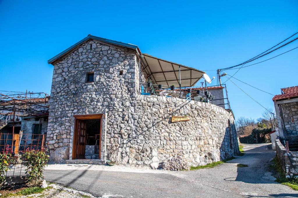 a stone building with a roof on top of it at Holiday Home Pavle in Rijeka Crnojevića