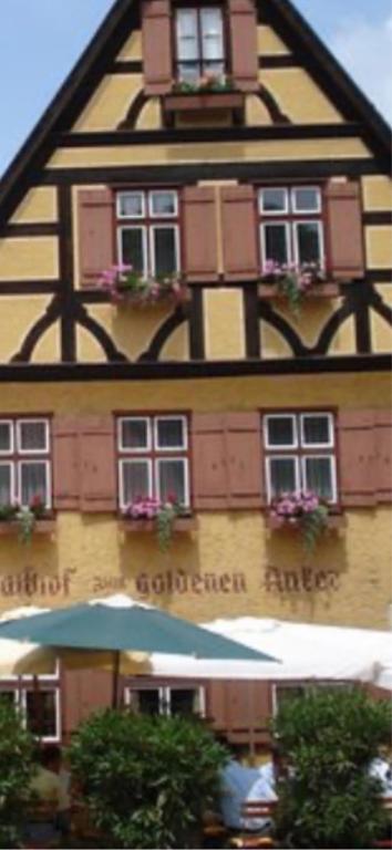 a building with an umbrella in front of it at Gästehaus Anker in Dinkelsbühl