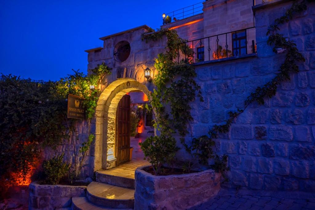an entrance to a building with an arch and lights at Sinasos Palace Cave Hotel in Urgup