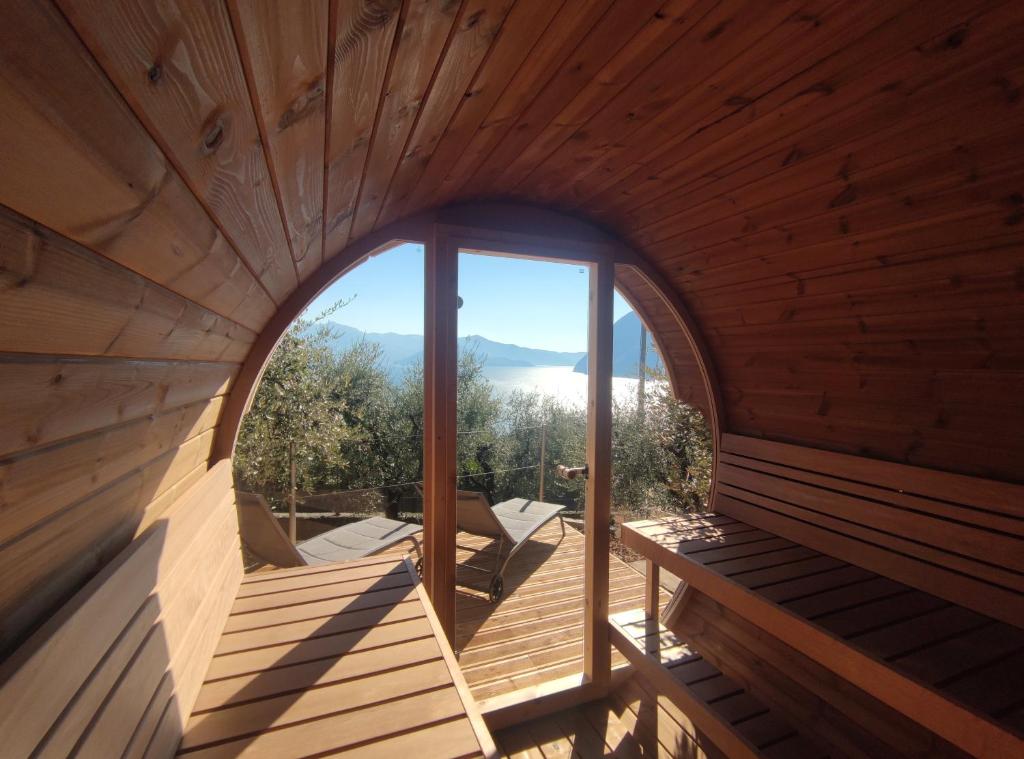 an inside view of a wooden room with a large window at Hotel Miranda in Riva di Solto
