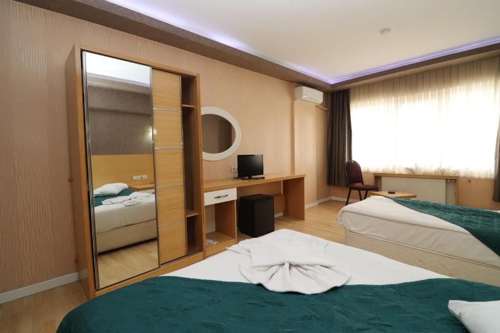 Posteľ alebo postele v izbe v ubytovaní Pera City Hotel