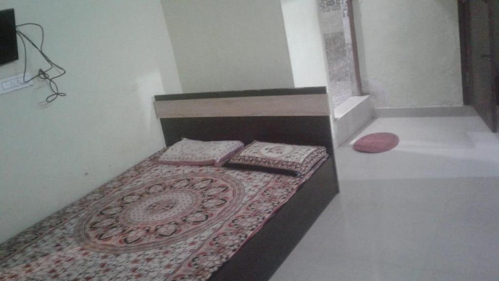 A bed or beds in a room at Xavier Guest House