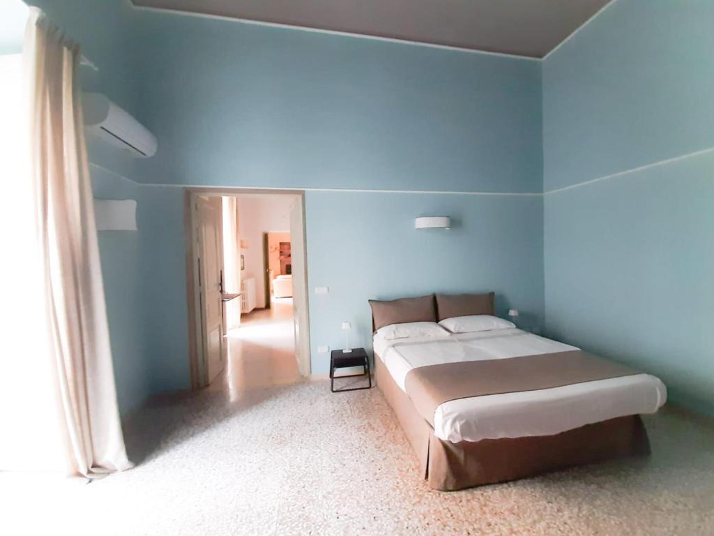 Postel nebo postele na pokoji v ubytování Palazzo Romanelli B&B