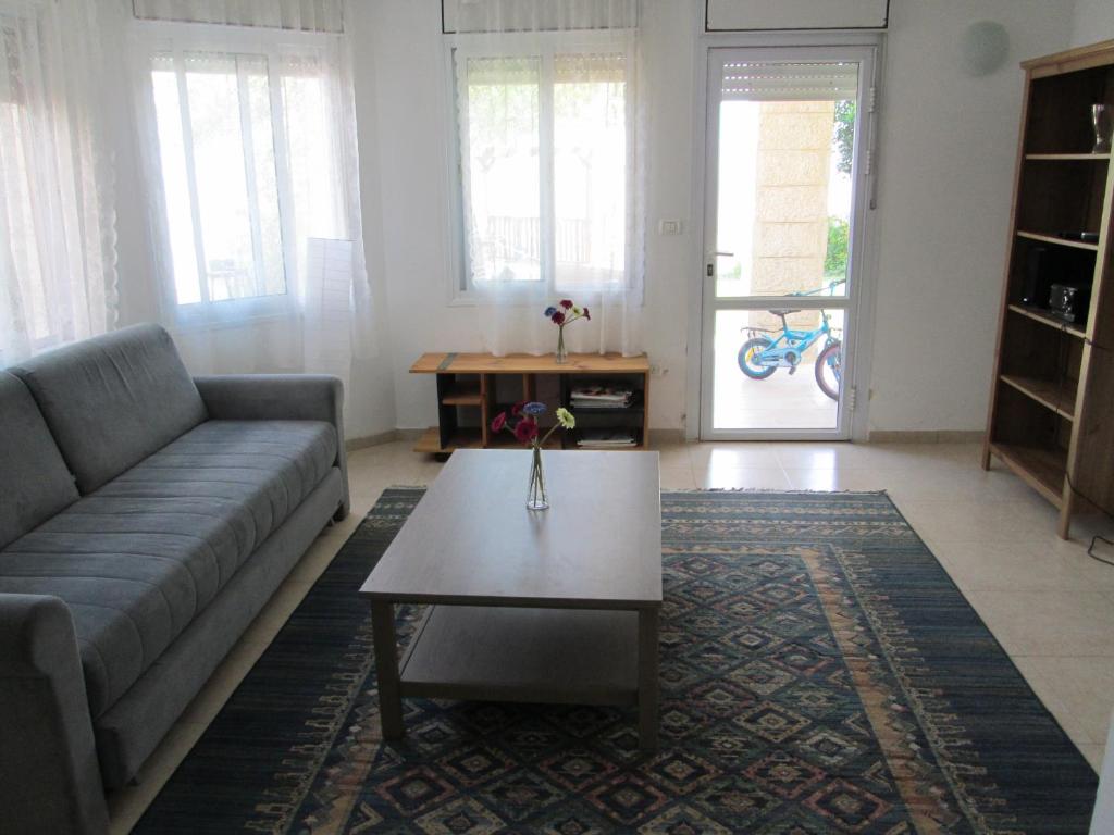 a living room with a couch and a coffee table at Apartment Tal in the Judean Desert in Kfar Adumim