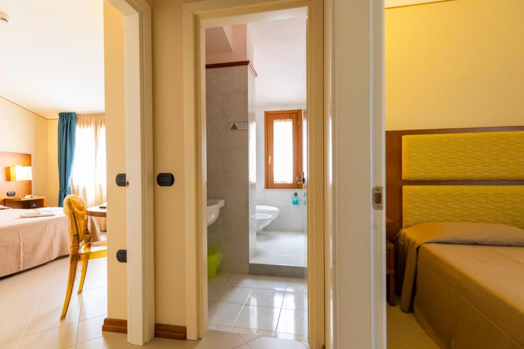 Postel nebo postele na pokoji v ubytování Hotel Tropis