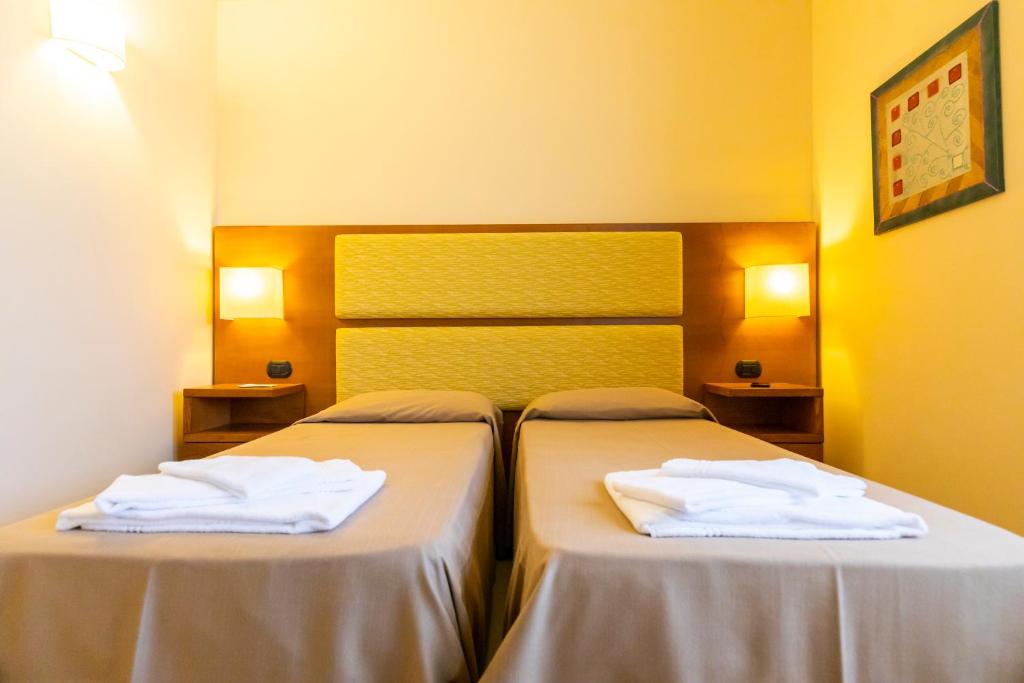 Postel nebo postele na pokoji v ubytování Hotel Tropis