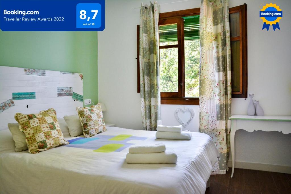 a bedroom with a white bed with pillows on it at El Rincón de Elsa VuT AV296 in Guisando
