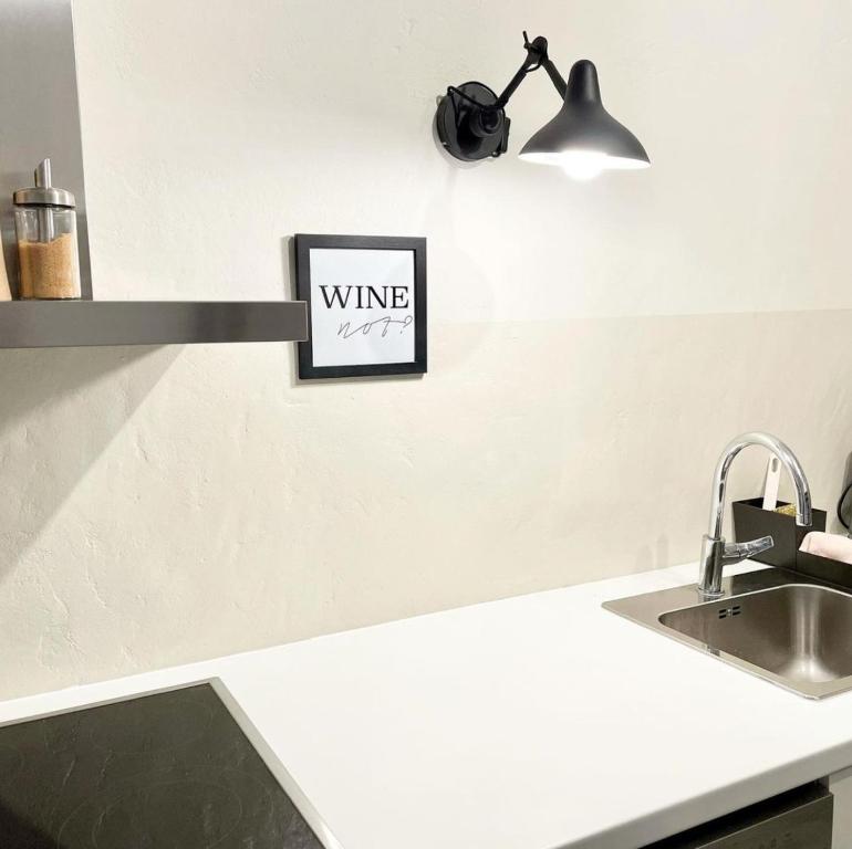 a kitchen counter with a wine sign on the wall at Friends and Family Leiwen in Leiwen