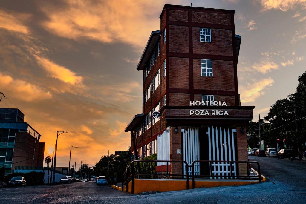 a tall brick building with a sign on it at Hostería Poza Rica in Poza Rica de Hidalgo