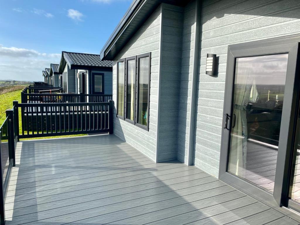 a porch of a house with a glass door at ELITE BLUE LUXURY 3 BEDROOM LODGE NEWQUAY, CORNWALL in Newquay